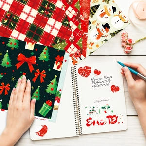 Detail view of festive Christmas scrapbook paper with red plaid and snowman patterns