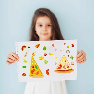 Close-up of a girl holding DIY cartoon pizza stickers with various food toppings