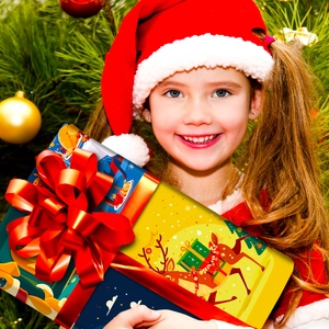 Close-up of a festive Christmas gift box with reindeer patterns and a red ribbon bow