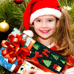 Girl holding Christmas gift boxes with snowman and tree patterns and red ribbons
