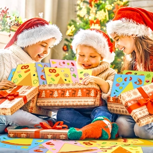 Three children opening a Christmas gift box filled with colorful cartoon pizza stickers
