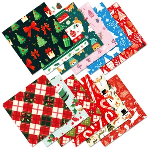 Macro shot of 12 festive Christmas craft paper patterns with reindeer and trees