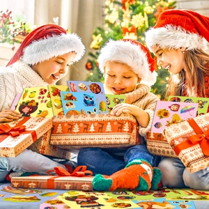 Kids in Santa hats playing with colorful harvest and animal stickers set near a tree