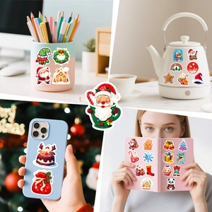 Detailed view of festive Christmas stickers applied on a water bottle and laptop