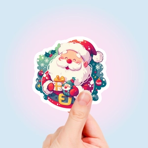 Nahaufnahme eines süßen Weihnachtsmann-Aufklebers mit Geschenkbox und weißem Rand