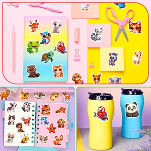 Close-up of cute cartoon animal stickers applied to a notebook and colorful water bottles