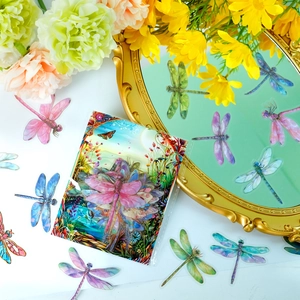 Macro shot of 3D gold-stamped dragonfly PET stickers with vintage mirror and flowers