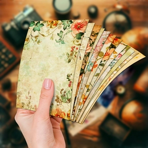 Close-up of vintage floral scrapbooking paper with aged texture and rustic flower patterns