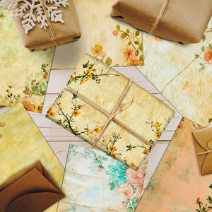 Macro detail of vintage floral patterned paper envelopes and scrapbooking material set