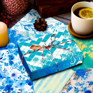 Macro view of blue floral scrapbooking paper wrapped around a gift box with cord