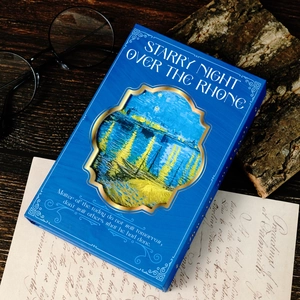 Macro view of Van Gogh starry night notebook with gold foil frame on wood