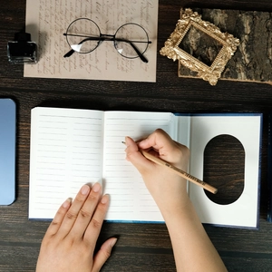 Vintage notebook with ruled cream pages, a wooden pencil, and retro study accessories