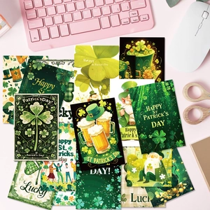 Flat lay of green St. Patrick's Day cards with clovers and leprechauns on a desk