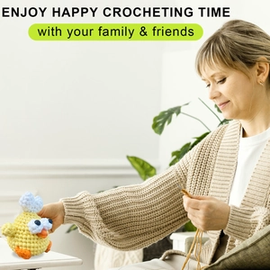Close-up of a person hands crocheting a yellow chick plushie with soft textured cotton yarn