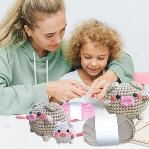 DIY Häkelset mit rosa Plüschschweinen und Wolle für handgemachten Strickspaß