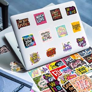 Detail of inspirational vinyl stickers applied to a silver laptop cover for decoration