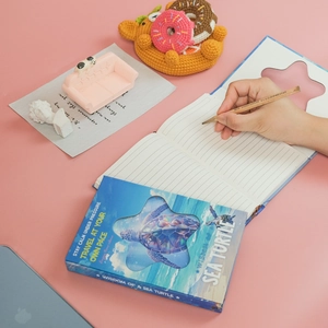 Blue sea turtle hardback notebook with starry ocean waves and die-cut star cover design