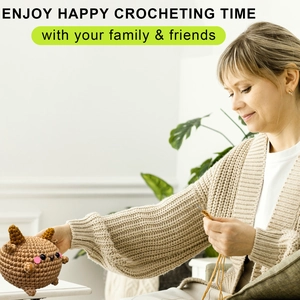 Close-up of handmade crochet sheep doll being crafted with yarn and hook