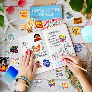 Macro shot of colorful inspirational vinyl stickers with beach themed summer props