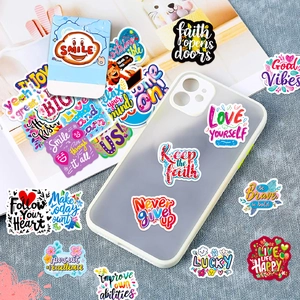 Waterproof PVC inspirational stickers applied on a phone case and scattered on background