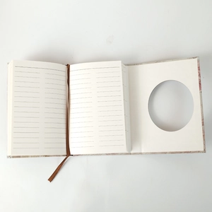 Detail view of lined pages and a ribbon bookmark inside a vintage hardcover journal