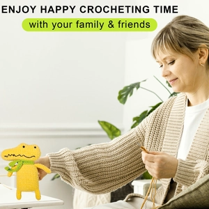 Macro detail of DIY crochet kit showing a yellow handmade crocodile with a green scarf