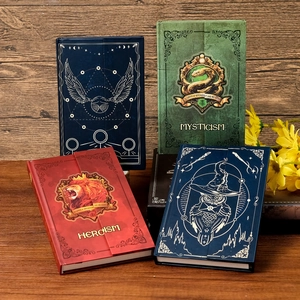 Detail of four magical wizard-themed hardcover notebooks with gold animal totem designs
