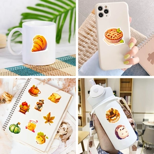 Close-up of Thanksgiving stickers on mugs, phone cases, and water bottles