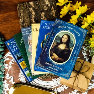 Artistic stationery set featuring oil painting notebooks like Starry Night on a lace mat