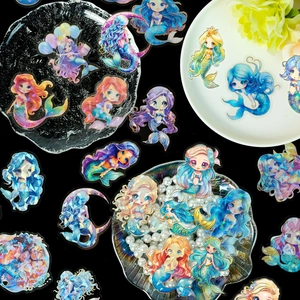 Macro shot of waterproof laser holographic mermaid stickers with gold foil details