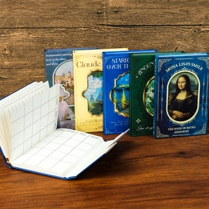 Detail of oil painting notebook showing monthly planner grid layout and art cover