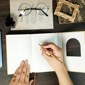 Close-up of vintage notebook with lined paper, featuring a pencil and retro desk accessories