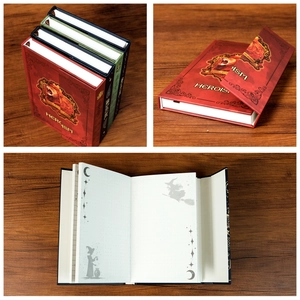 Detailed macro view of the magic totem notebook showing vintage lion crest and inner pages