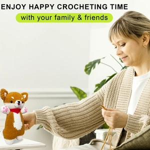 Detail showing a handmade crochet Shiba Inu puppy doll with a red scarf and DIY tools