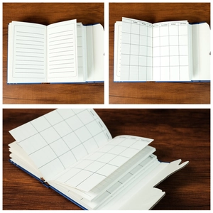 Detailed interior of blue oil painting notebook showing lined pages and weekly planner grids