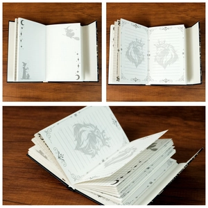 Detailed interior view of magic totem notebook showing lined, grid, and dot pages