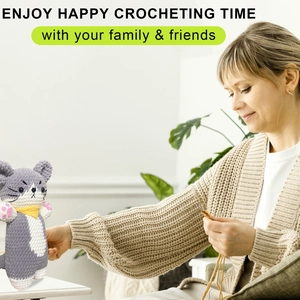 Detail of a handmade grey crochet cat plush with a yellow scarf for DIY keychains