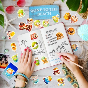 Close-up of cute cat and dog beach stickers with ice cream on a notebook and wooden desk