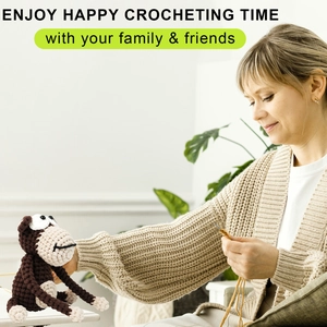 Close-up of DIY crochet process showing a cute brown gorilla doll and knitting tools