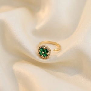 Adjustable gold clover ring with green gemstone and micro-pave crystals on silk