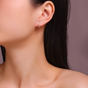 Close-up of 18k gold plated S925 silver hoop earrings with pave moissanite on ear