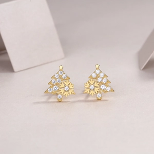 Detailed close-up of 18k gold Christmas tree stud earrings with zircon snowflakes