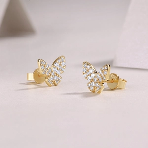 Macro shot of S925 sterling silver gold butterfly earrings with sparkling cubic zirconia