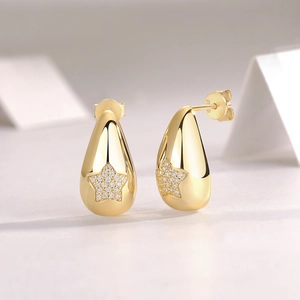 Detail view of gold S925 sterling silver teardrop earring with star-shaped moissanite inlay