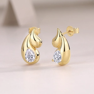 Macro detail of S925 hallmark on gold plated silver earrings with pear cut zircon