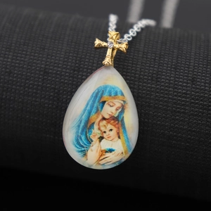 Religious pendant necklace featuring Virgin Mary portrait and gold cross on black base