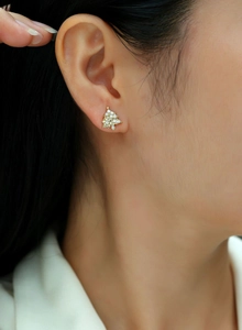 Close-up of S925 sterling silver Christmas tree stud earrings with gold plating and zircons