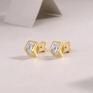 Macro detail of geometric cube earrings in 18k gold plated silver with moissanite stones