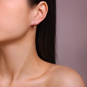 Close-up of elegant gold plated 925 silver hoop earrings with shimmering moissanite stones
