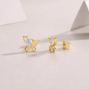 Macro view of gold S925 silver butterfly earrings with marquise-cut moissanite stones